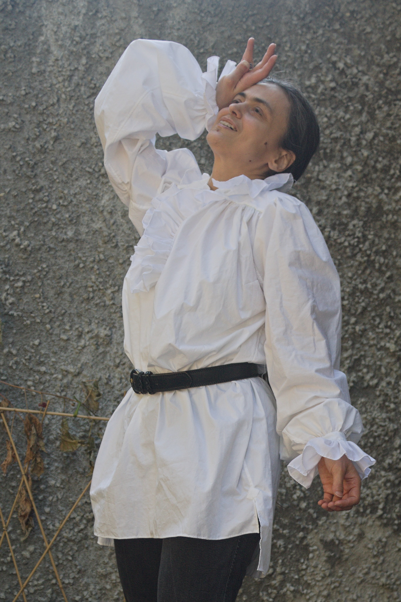Same woman and shirt, back with the ruffled collar, in a pose
like that of an artist that is fainting for futile reasons. Drama
levels over the top.