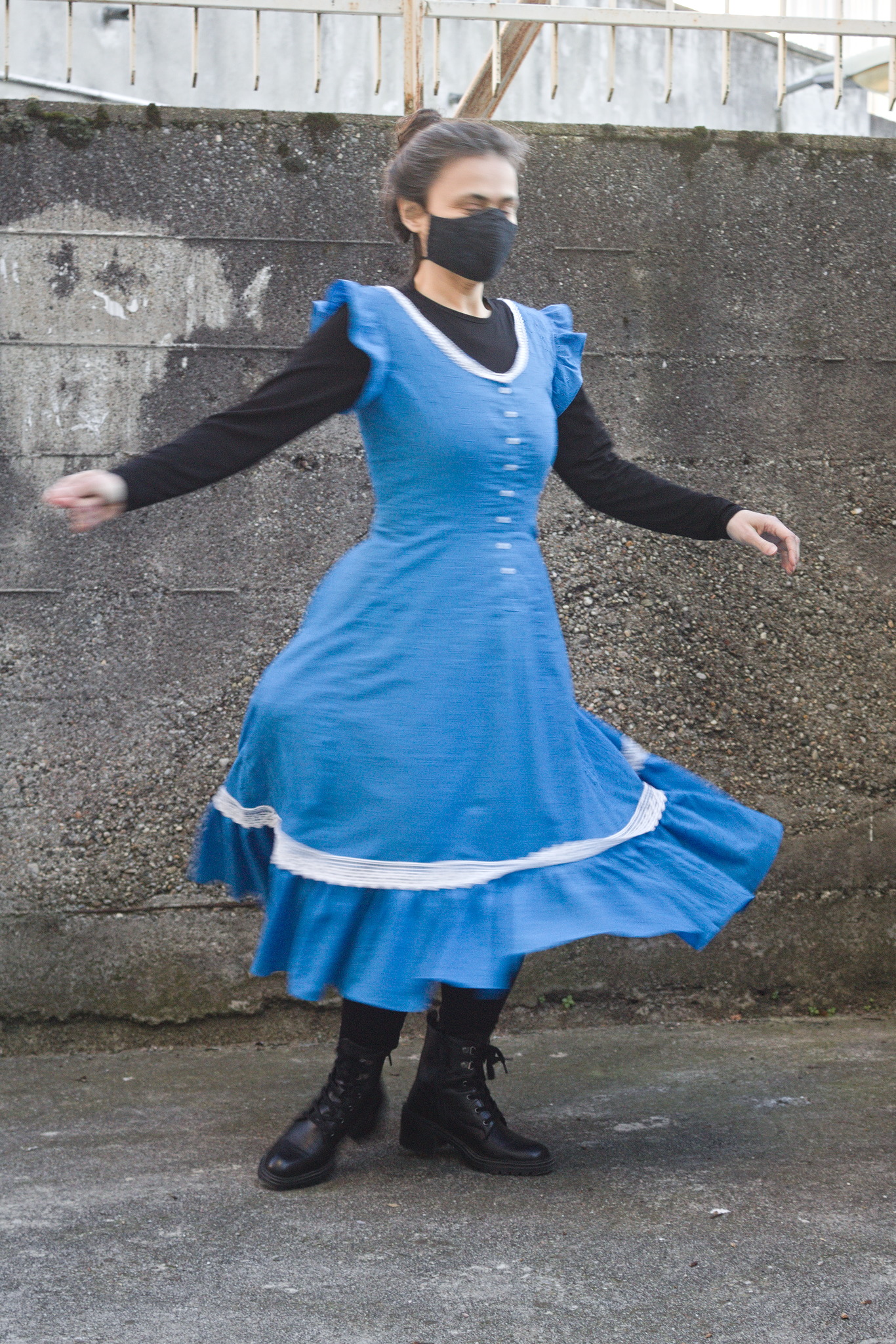 a person spinning on herself, the skirt and the ruffle are
swishing out. Something in the pocket worn under the dress is
causing a bit of bulge on one side.