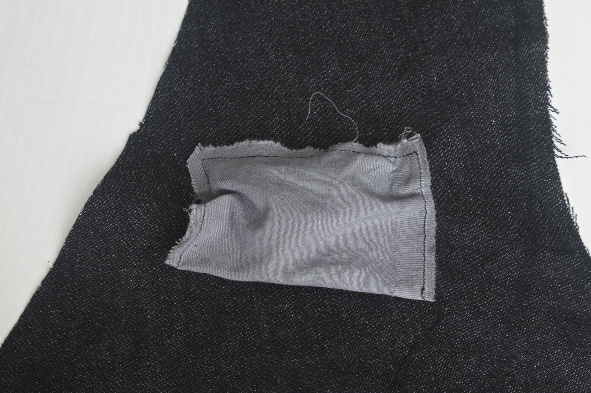 a piece of pocketing fabric folded in half and sewn on all 3