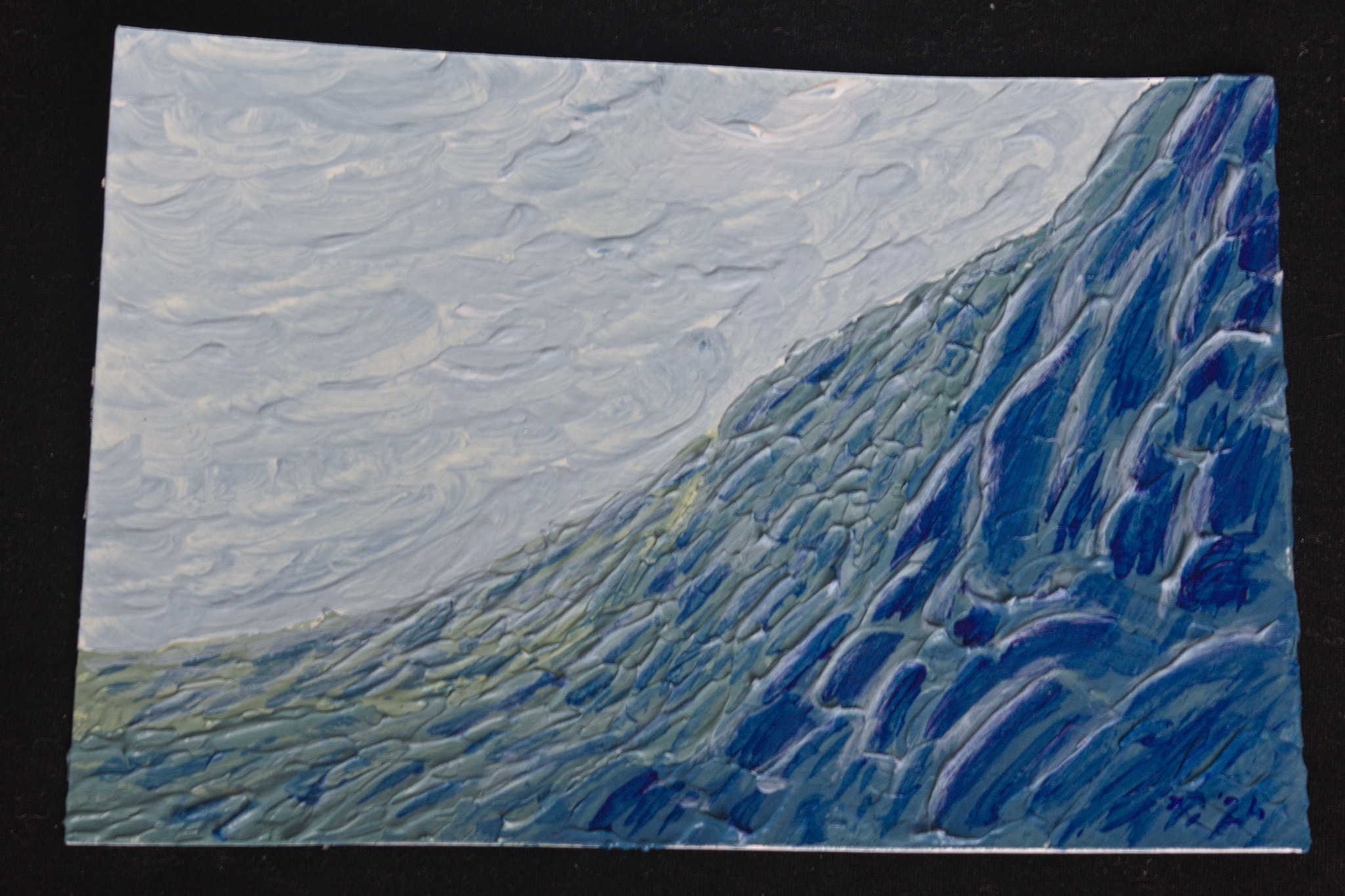 An acrylic painting in blue and greenish grey vaguely resembling rocky slopes at the bottom right and a cloudy sky at the top left.