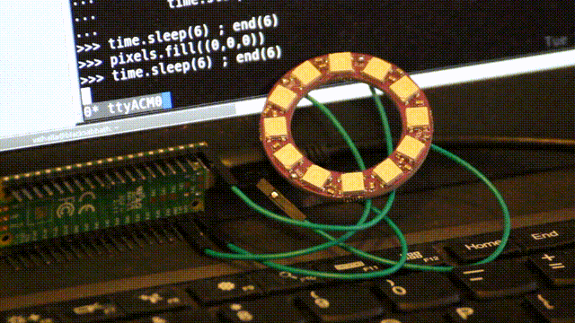 low quality video of a ring of rgb LED in front of a computer: the LED light up one at a time in colours that go from yellow to red.