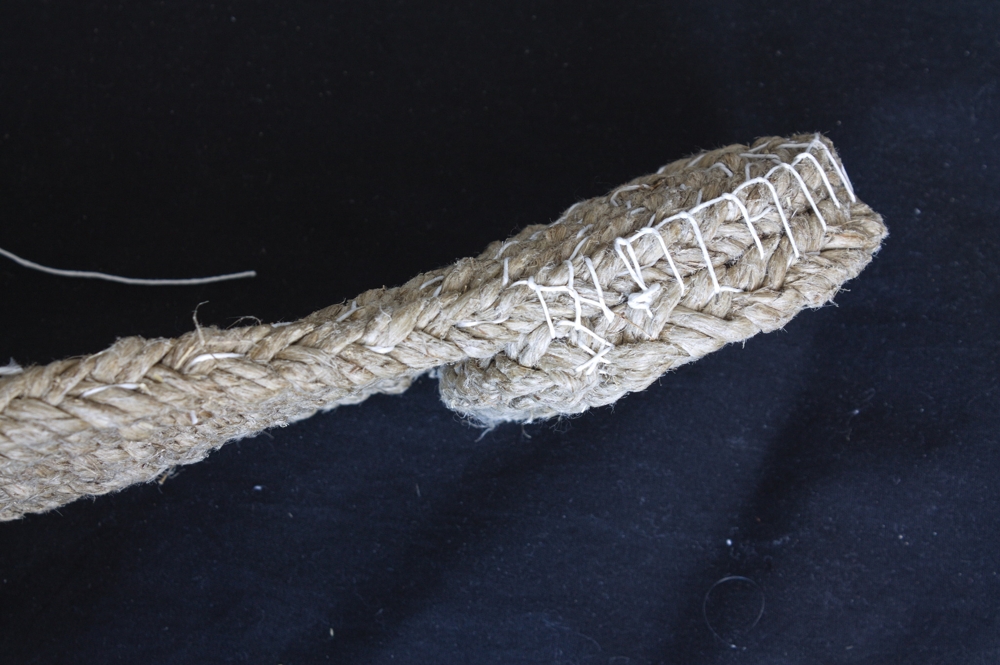 A braided twine sole, showing how an heel has been made in the
same technique and sewn under the sole with blanket stitches.