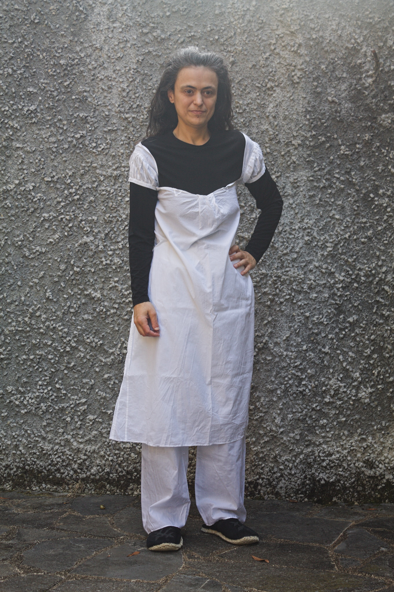 A woman wearing a knee-length shift with very short pleated
sleeves and drawers that are a bit longer than needed to be
ankle-length. The shift is too wide at the top, had to have a
pleat taken in the center front, but the sleeves are still falling
down.
She is also wearing a black long sleeved t-shirt and leggings
under said underwear, for decency.